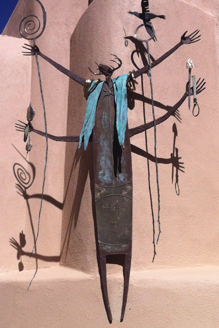 Intriguing metal sculpture casting shadows in Santa Fe, showcasing abstract art elements.